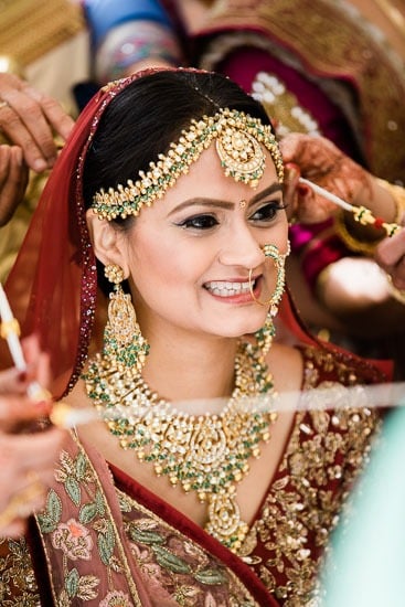Bride adorned in traditional wedding jewelry.