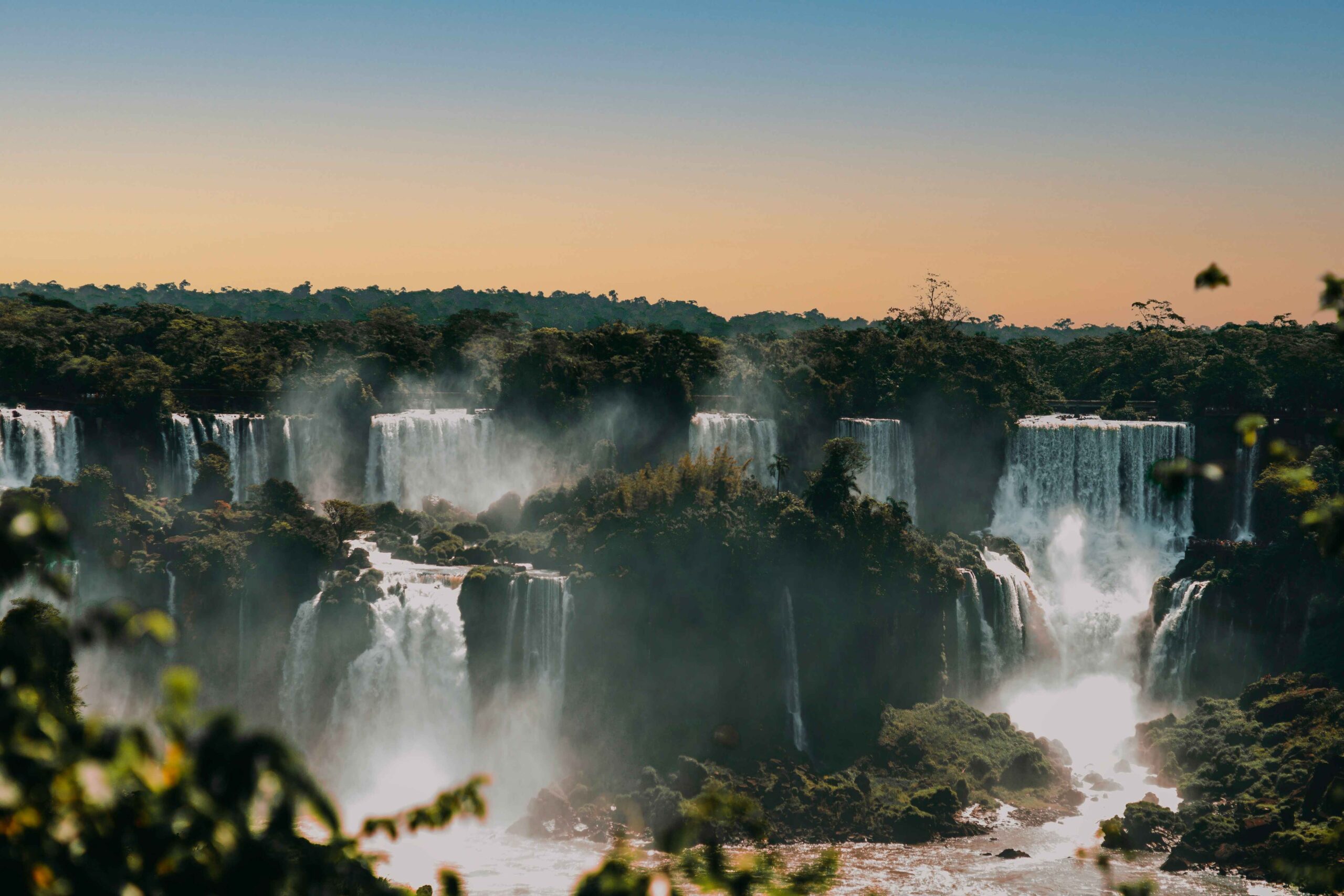 Scenic view of majestic waterfalls at sunset.